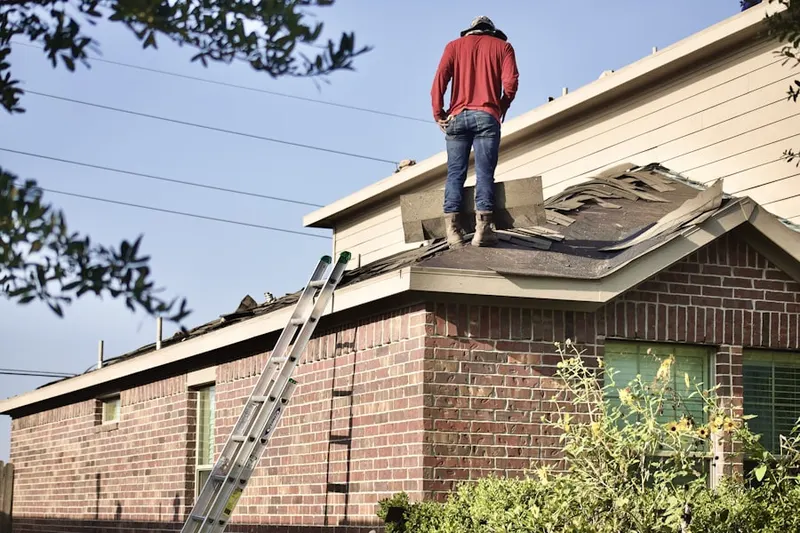 Professional roofer working on a residential roof in South Prairie
